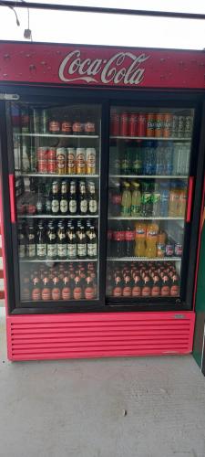 a coca cola cooler with drinks and drinks at Apartmani Kovačević MKM Banja Vrujci in Gunjica