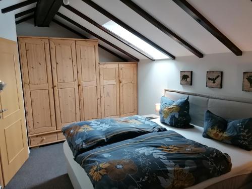 a bedroom with a bed and some wooden cabinets at Appartement Auszeit in Olsberg