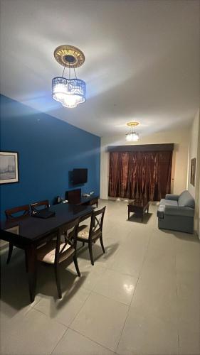 a living room with a table and a couch at Clifton International Hotel in Fujairah