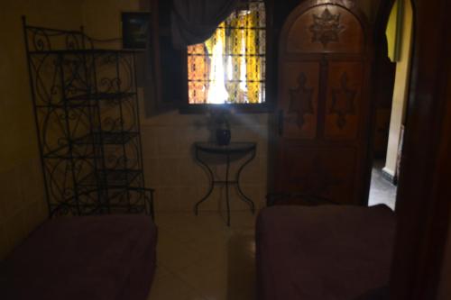 a room with a window and a table and a chair at Riad Hôtel Belleville Marrakech in Marrakech