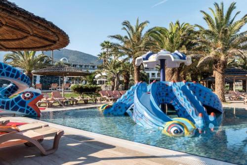 a water slide in a pool at a resort at Samara Hotel Bodrum Ultra All Inclusive in Torba
