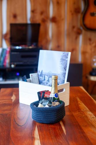 a bottle of champagne and a box of cookies on a table at APARTMA JEREBIKA ŠT. 20 in Pohorje