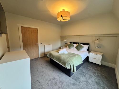 a bedroom with a bed and a light at Sandbed in Hawick