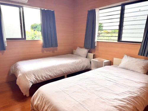 Postel nebo postele na pokoji v ubytování AZホテル Inn 奄美万屋 - Villa with private outdoor Jacuzzi