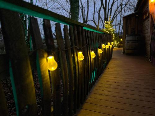 a row of lights on a fence at night at Burtree Country House, Tipi's, Treehouse & Lodge & house rooms with hot tubs in a private garden in Thirsk