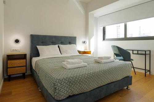 a bedroom with a bed with two towels on it at Luxurious Athens Residence in Athens