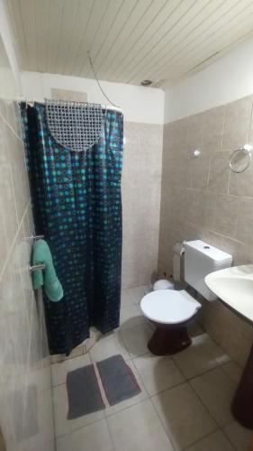 a bathroom with a toilet and a shower and a sink at Guenechen in Colorado River