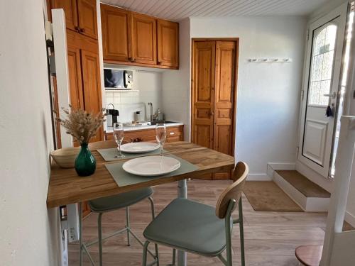 une petite cuisine avec une table et des chaises en bois dans l'établissement Maison de ville idéalement située à Châtel-Guyon, à Châtel-Guyon