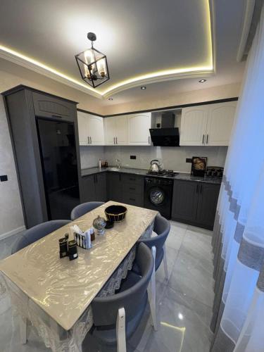 a kitchen with a table and some blue chairs at Gabala Double Villas in Gabala