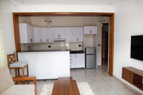 a kitchen with white cabinets and a white counter top at MARA Apartments in Gisenyi