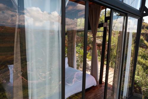a room with a view of a mountain through a window at REFUGIO LA ROCA in Los Santos