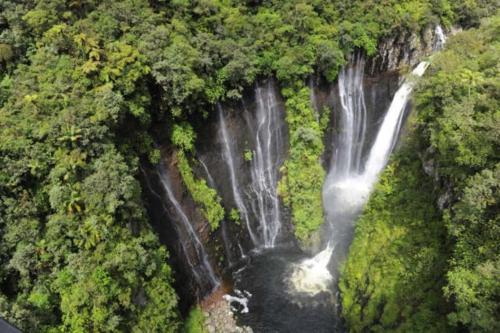 an aerial view of a waterfall in a forest at Bungalow L'escale de Takamaka in Saint-Benoît