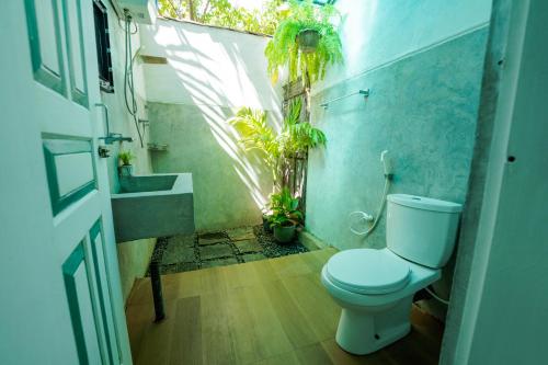 a bathroom with a toilet and a sink at ceylonza in Kamburugamuwa