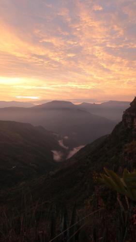 a view of a valley from a mountain at sunset at REFUGIO LA ROCA in Los Santos