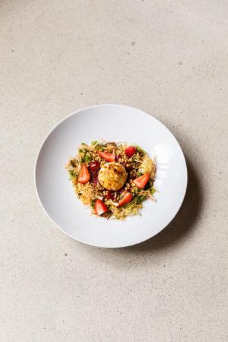 a white plate of food on a table at Viceroy Chicago in Chicago