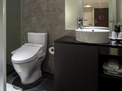 a bathroom with a toilet and a sink at Hotel Relax I in Taipei