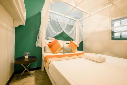 a bedroom with two beds and a window at ceylonza in Kamburugamuwa
