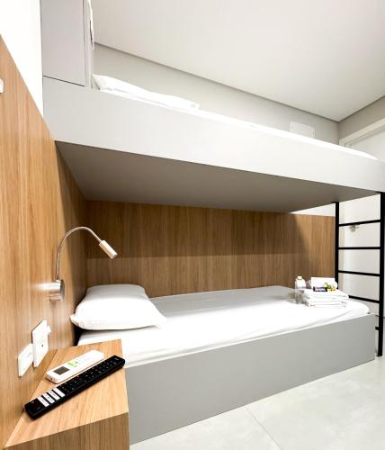 a bunk bed in a room with a desk at Hotel São José in São José