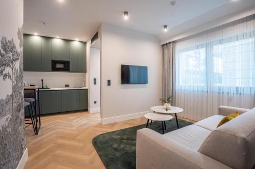 a living room with a couch and a table at Larum Balatonfüred - Adults only in Balatonfüred