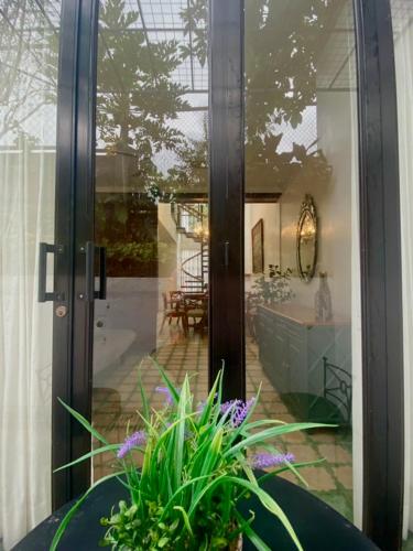 a glass door of a house with a plant at The Gallery House in Ulot