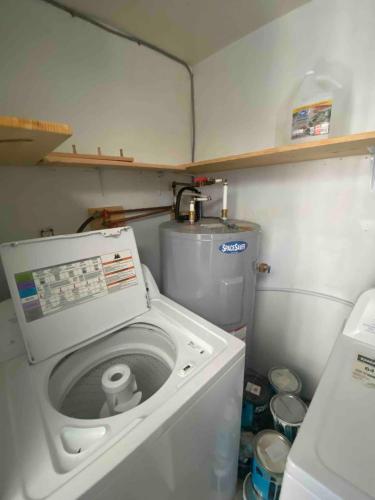 a washer and dryer in a small kitchen at Adventure Haven Hot Tub & Quidi Vidi Charm in St. John's