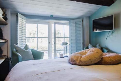 a bedroom with a bed with two pillows on it at B&B Hullebrug in Heist-op-den-Berg