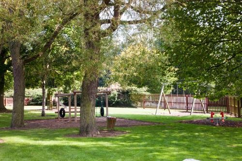 a park with a playground with a swing at Holiday Inn Stoke on Trent M6 Jct15 by IHG in Stoke on Trent