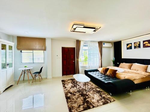 a living room with a couch and a table at Vibe Phuket Relax in Town in Phuket Town