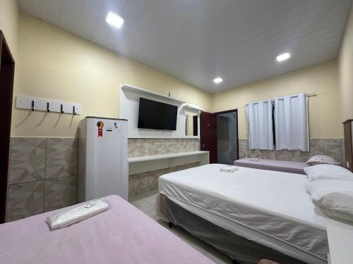 Ένα ή περισσότερα κρεβάτια σε δωμάτιο στο Hotel Maracá