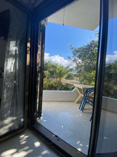 a sliding glass door with a view of a patio at Orthi Ammos in Frangokastello