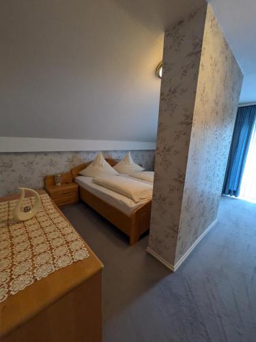 a hotel room with two beds and a window at Pension Dornröschen in Bad Füssing