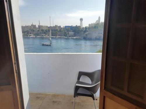 a view of a river from a window with a chair at Malika nubian house in Aswan