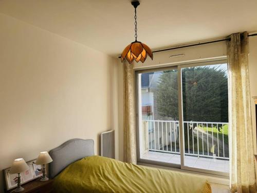 une chambre avec un lit et une grande fenêtre dans l'établissement Spacieux 2 pièces vue mer, parking, wifi, à Quiberon