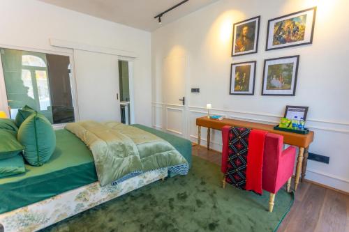 a bedroom with a bed and a desk in it at The Zoey Villa, with Central Heating, Bonfire, BBQ & Complimentary Breakfast in Gulmarg