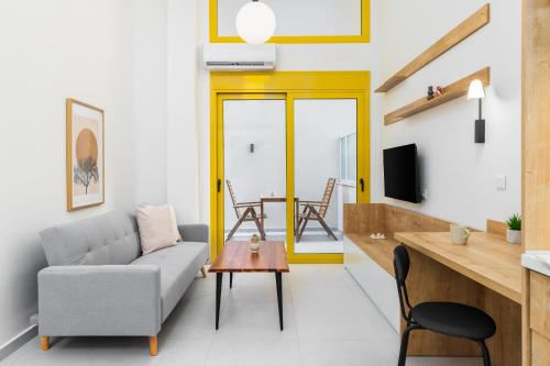 a living room with a couch and a table at Soho Harbor by halu! in Thessaloniki