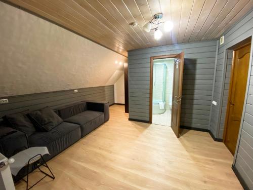 a living room with a couch and a hallway at Готель Поляницький in Bukovel