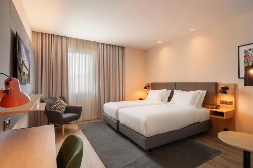 a hotel room with a bed and a desk at Holiday Inn Braga by IHG in Braga