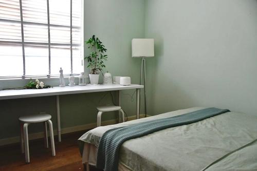 a bedroom with a bed and a window with two stools at Shanghai Hills & Moment Family house close to The Bund in Shanghai