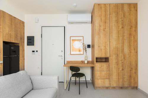 a living room with a couch and a desk at Soho Harbor by halu! in Thessaloniki