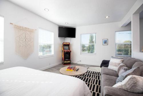 a living room with a bed and a couch at The Barber Loft-Close to Downtown 35 Mins to Ski in Salt Lake City