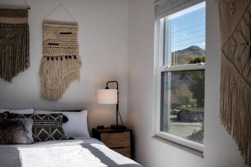 a bedroom with a bed and a window at The Barber Loft-Close to Downtown 35 Mins to Ski in Salt Lake City