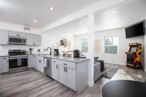 a kitchen with white cabinets and a counter top at The Barber Loft-Close to Downtown 35 Mins to Ski in Salt Lake City
