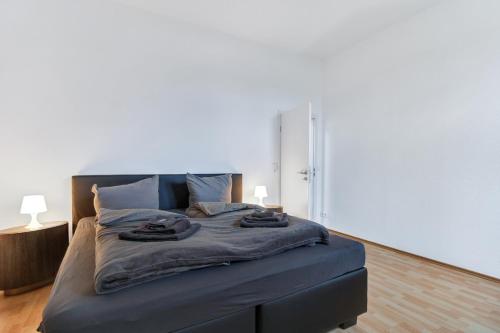 a bedroom with a blue bed with two towels on it at 24-7 Living - Modern Apartments in Waltrop with Top Connection in Waltrop