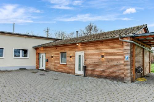 a wooden building with a parking lot in front of it at 24-7 Living - Modern Apartments in Waltrop with Top Connection in Waltrop