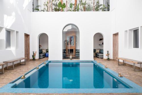 a pool in the middle of a building at Riad Zyo in Rabat