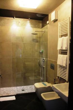 a bathroom with a shower and a toilet and a sink at La Casa Degli Angeli - Agli Angeli Ristorante Pizzeria in Pertegada
