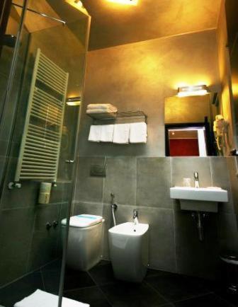 a bathroom with a toilet and a sink at La Casa Degli Angeli - Agli Angeli Ristorante Pizzeria in Pertegada