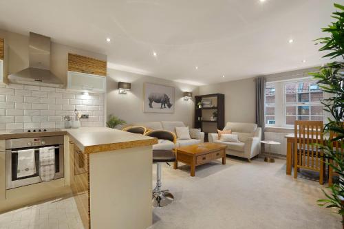 a living room with a kitchen and a living room with a couch at NEW! 2BR in Stephenson House in Stockton-on-Tees