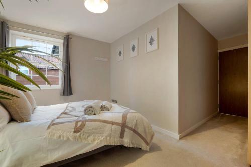 a bedroom with a bed and a window at NEW! 2BR in Stephenson House in Stockton-on-Tees
