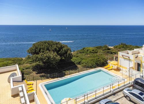 a swimming pool with a view of the ocean at Seaview Benagil Villa 15 in Benagil